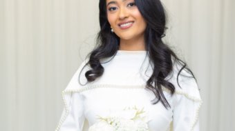 Candid wedding portrait of a bride and groom smiling at each other during a ceremony in Tampa FL by imkashi Photography