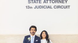 Candid wedding portrait of a bride and groom smiling at each other during a ceremony in Tampa FL by imkashi Photography