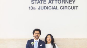 Candid wedding portrait of a bride and groom smiling at each other during a ceremony in Tampa FL by imkashi Photography