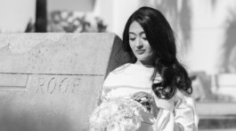 A newly married couple smiling and walking down the steps of the Hillsborough County Courthouse after their downtown Tampa wedding ceremony by imkashi Photography