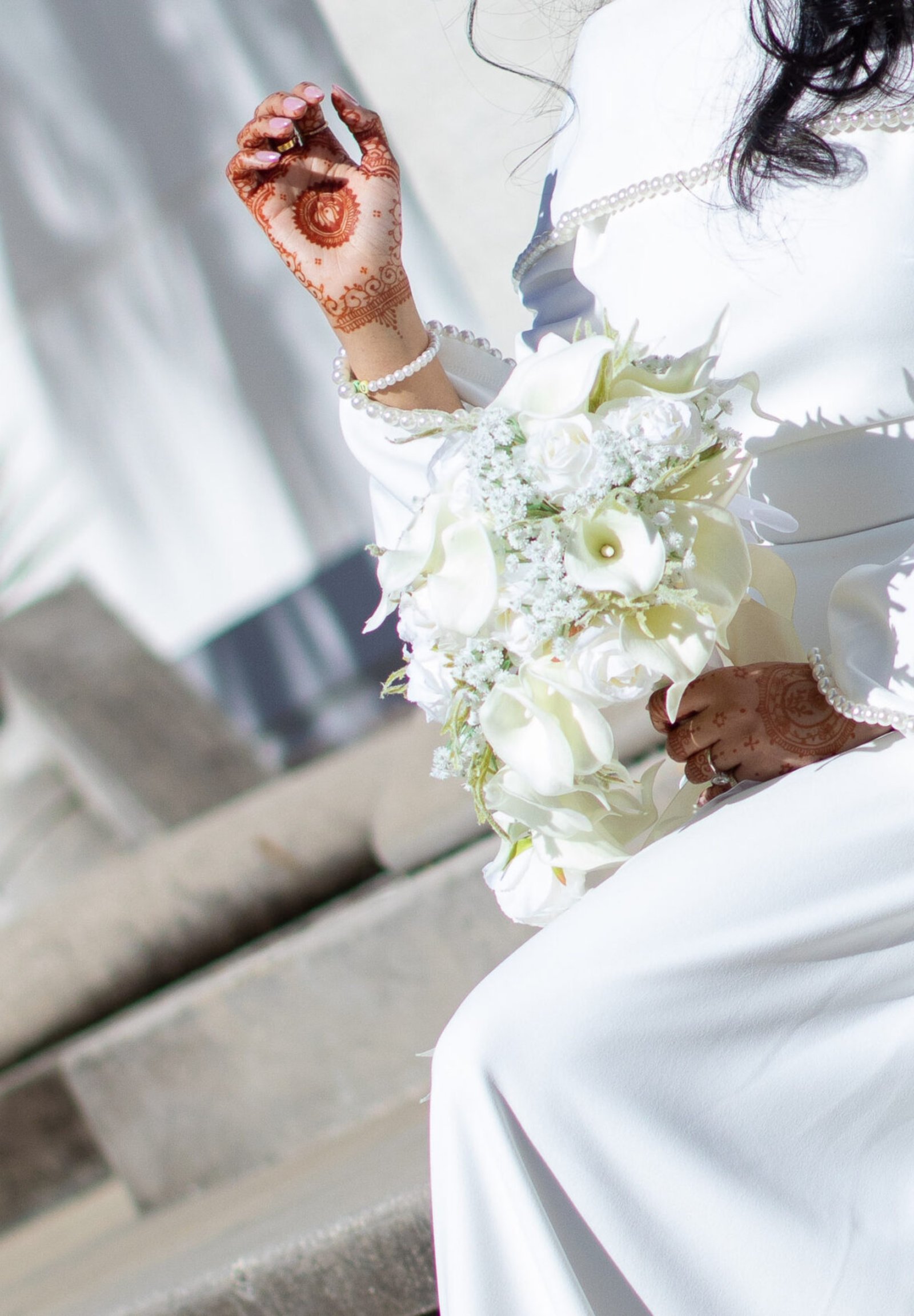 A newly married couple smiling and walking down the steps of the Hillsborough County Courthouse after their downtown Tampa wedding ceremony by imkashi Photography