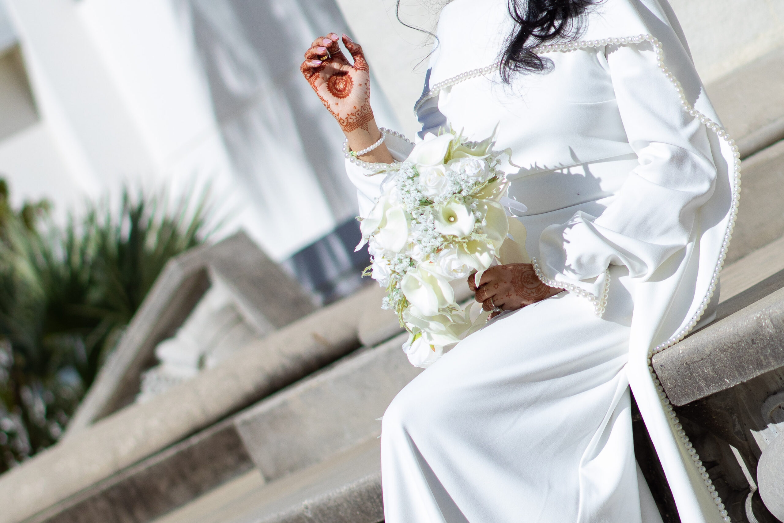 A newly married couple smiling and walking down the steps of the Hillsborough County Courthouse after their downtown Tampa wedding ceremony by imkashi Photography