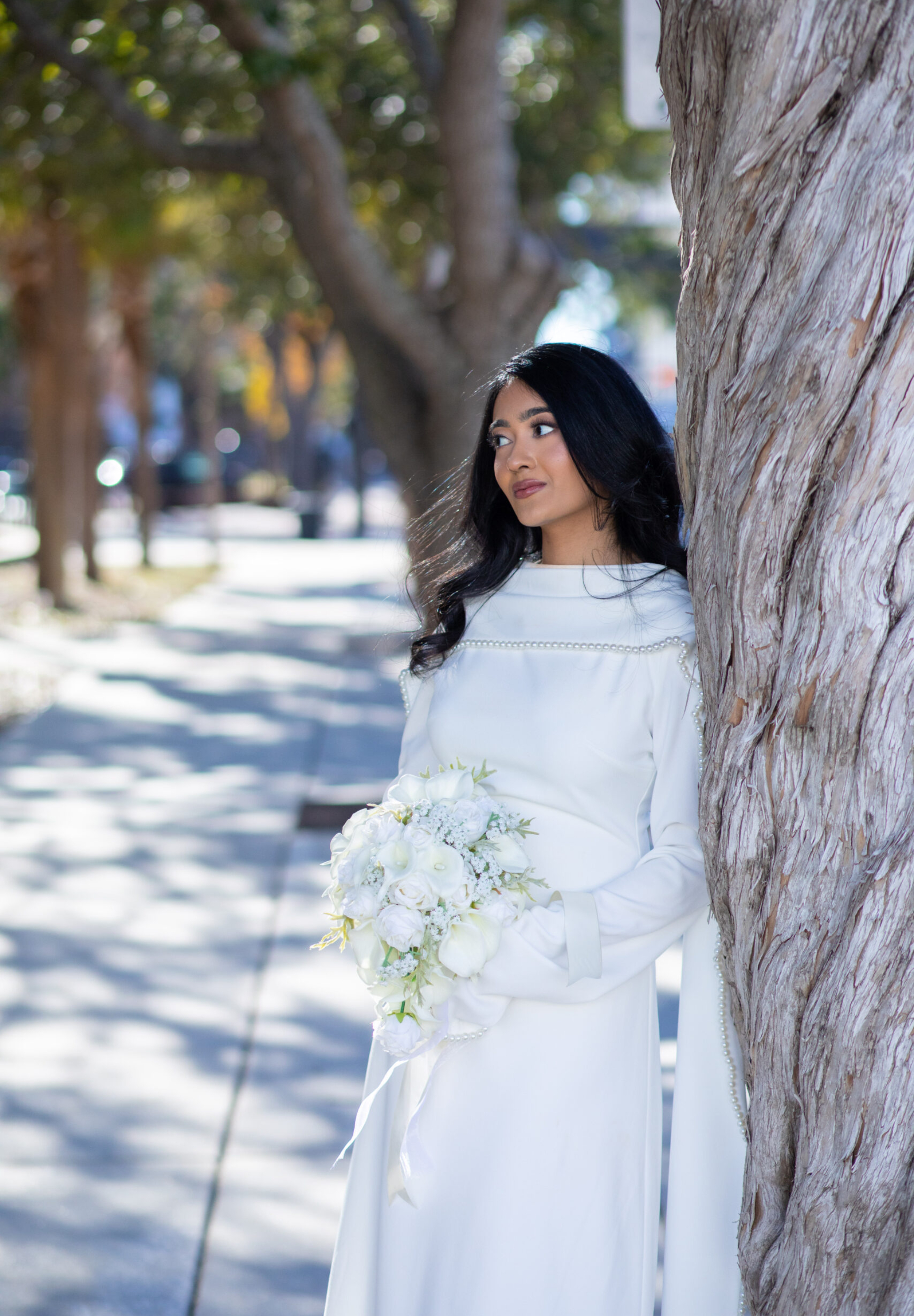 Home Page A newly married couple smiling and walking down the steps of the Hillsborough County Courthouse after their downtown Tampa wedding ceremony by imkashi Photography