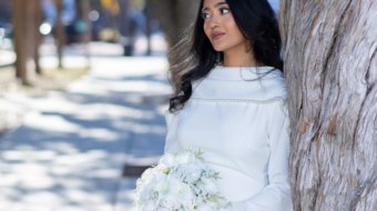 A newly married couple smiling and walking down the steps of the Hillsborough County Courthouse after their downtown Tampa wedding ceremony by imkashi Photography