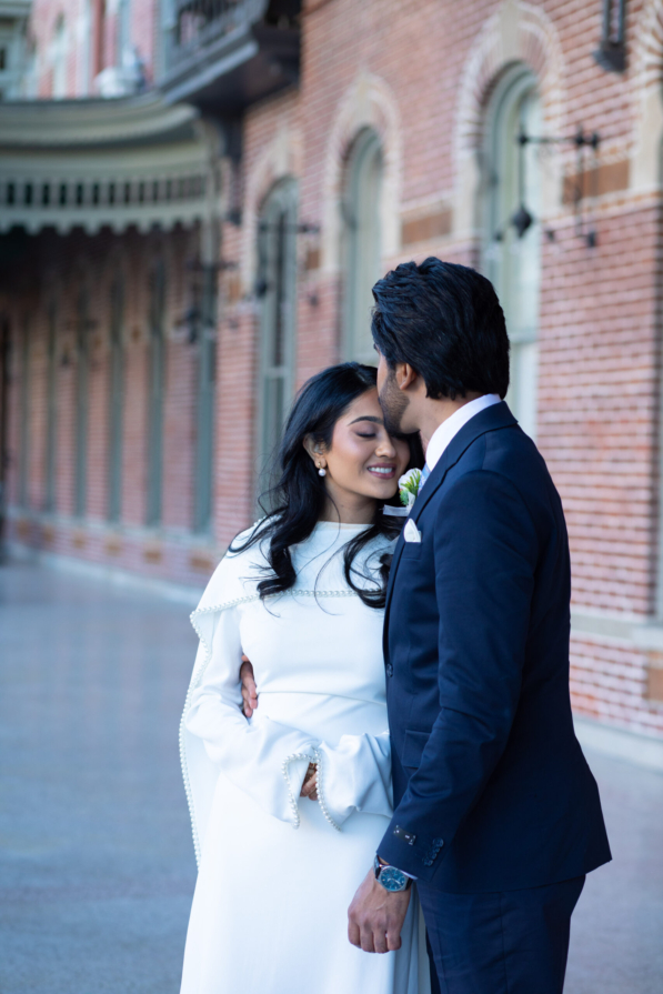 A bride and groom posing for romantic wedding portraits in downtown Tampa near the courthouse squares with city architecture backgrounds by imkashi Photography