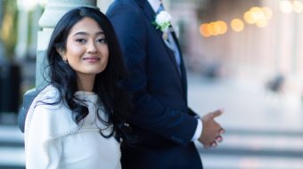 A bride and groom posing for romantic wedding portraits in downtown Tampa near the courthouse squares with city architecture backgrounds by imkashi Photography