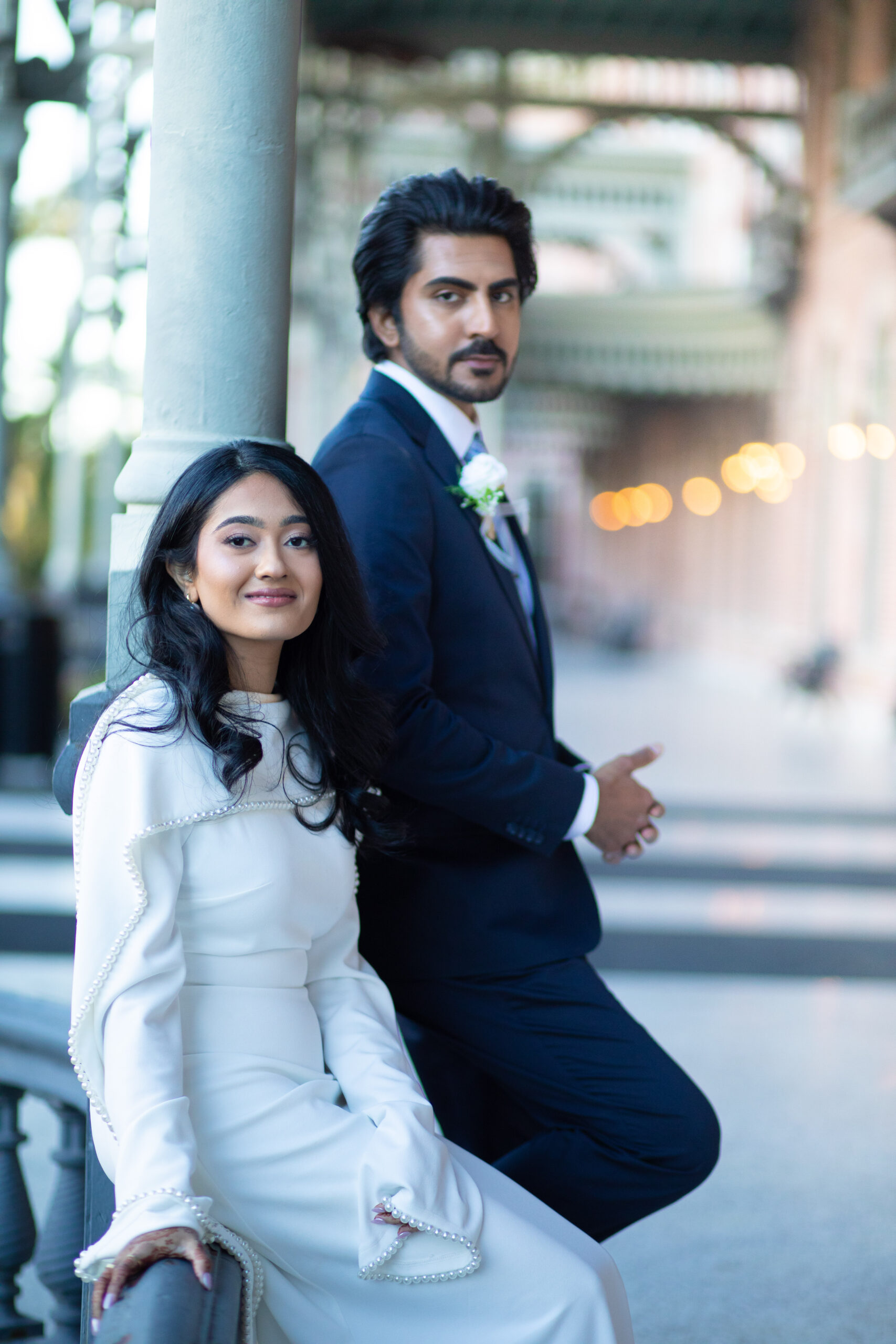 A bride and groom posing for romantic wedding portraits in downtown Tampa near the courthouse squares with city architecture backgrounds by imkashi Photography