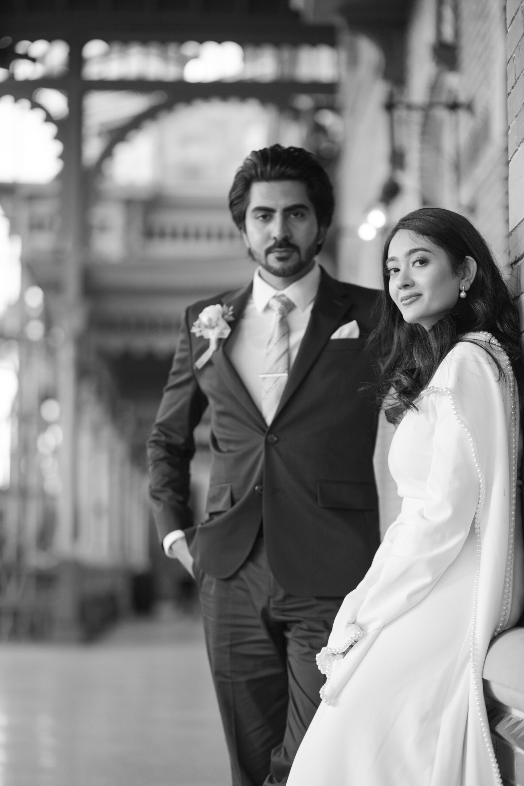 A bride and groom posing for romantic wedding portraits in downtown Tampa near the courthouse squares with city architecture backgrounds by imkashi Photography