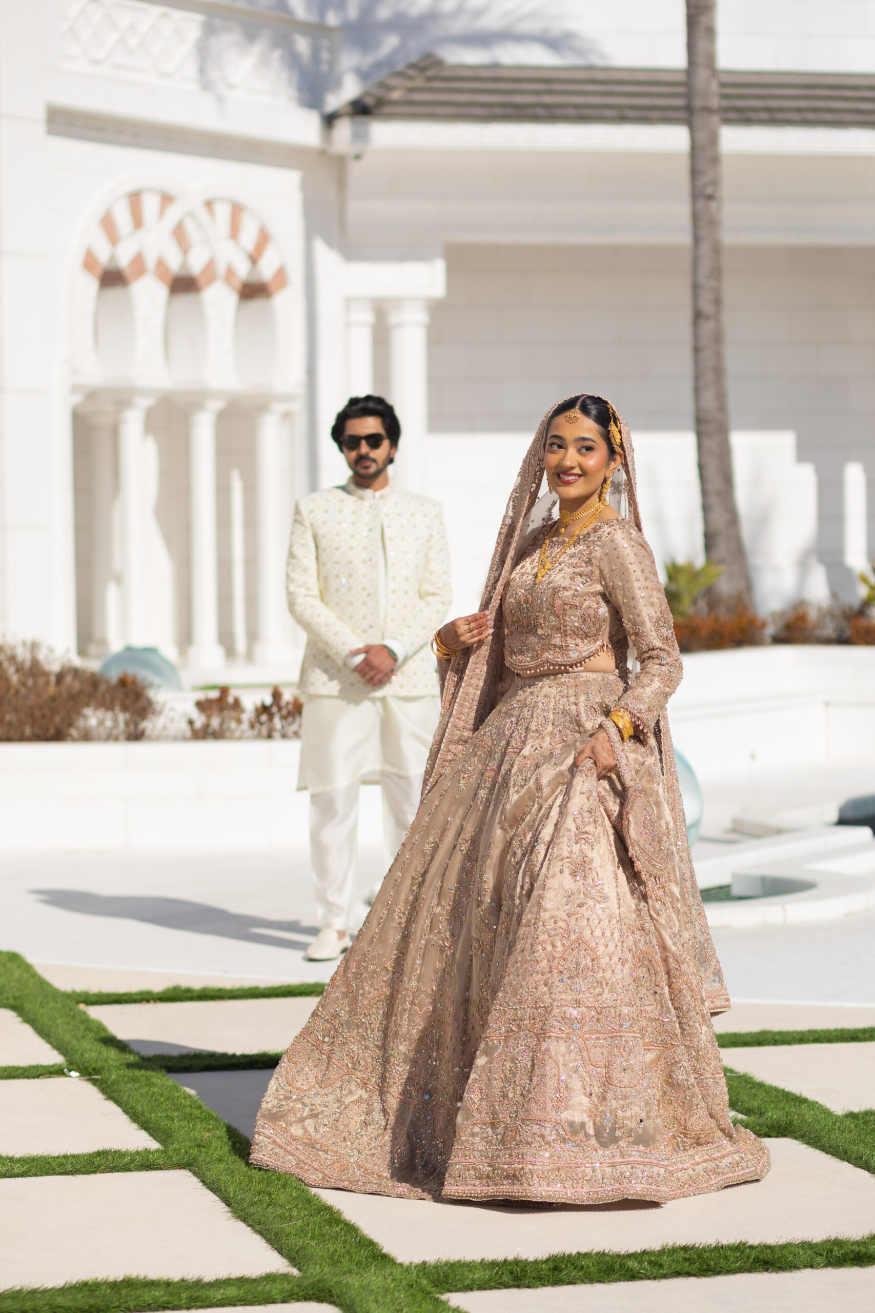 A newly married couple smiling and walking down the steps of the Hillsborough County Courthouse after their downtown Tampa wedding ceremony by imkashi Photography